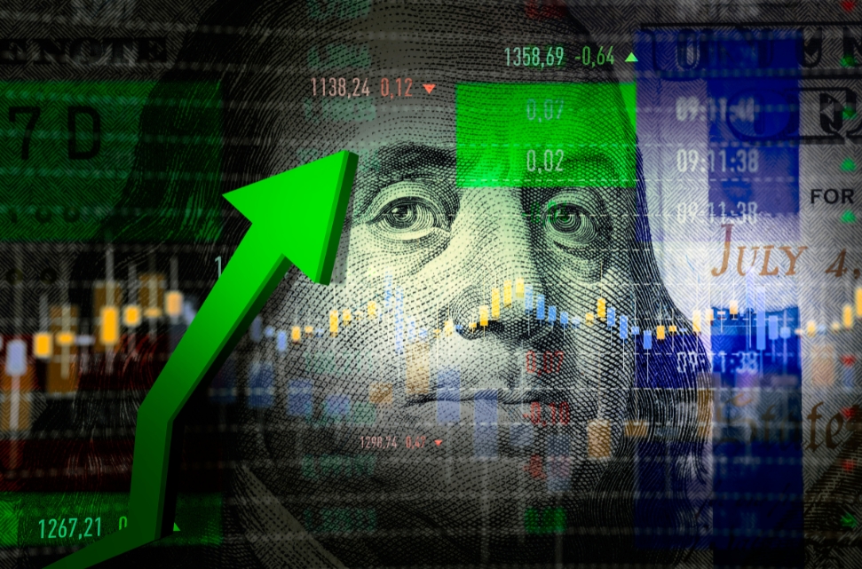 A collage of financial elements features Benjamin Franklin's face from a US hundred-dollar bill in the background. A green upward arrow indicates growth, as stock market charts and numbers merge with a jobs report to symbolize economic progress.